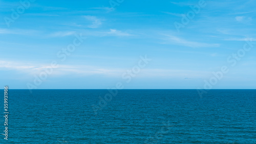 Bright blue sky with white clouds for background or wallpapers.The beauty of tropical nature, Chanthaburi province, Thailand, horizon, seascape, sea connect to the sky 
