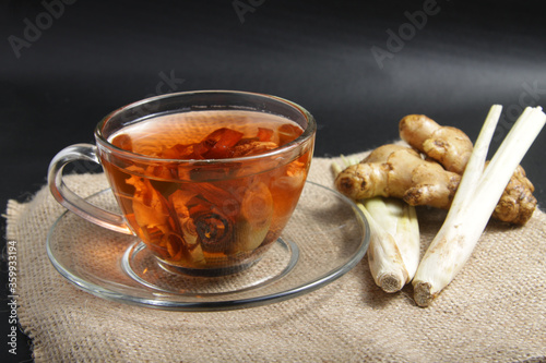 Picture of traditional herbal drink that contains ginger, clove, limegrass, cinnamons and secang (Caesalpinia sappan L) for immunity improvement photo