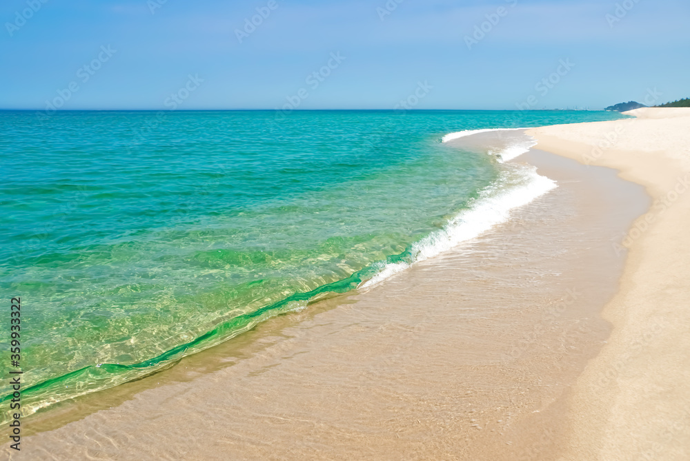 Beautiful coastline with emerald blue green water. Beach landscape with  aquamarine water and white sand.    