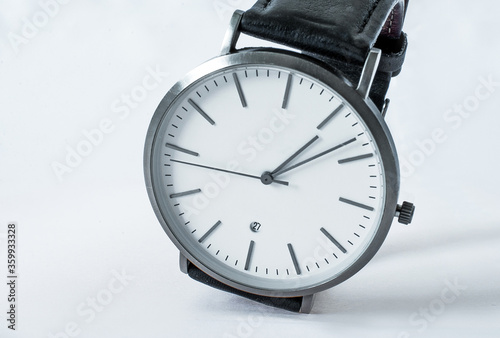Hand Watch Isolated on White Background. Men's silver watch with a black strap. Hand Watch close up.