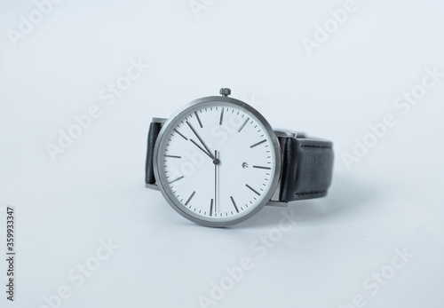 Hand Watch Isolated on White Background. Men's silver watch with a black strap. Hand Watch close up.