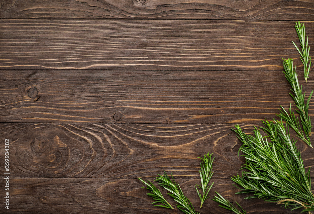 Fresh rosemary sprigs on rustic kitchen table
