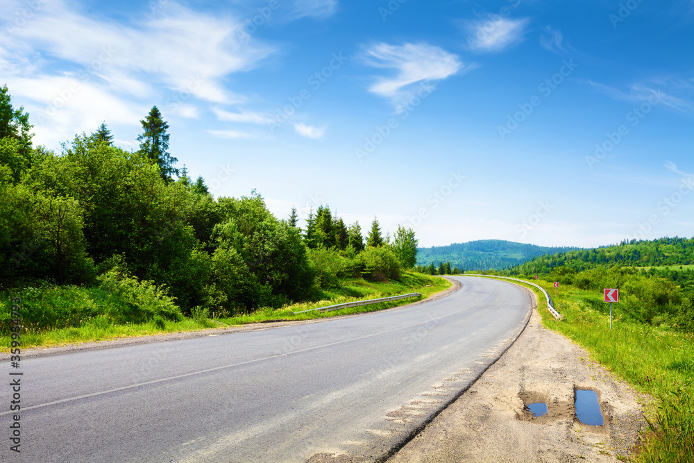 Road along mountain forest in summer day Road along mountain forest in summer day