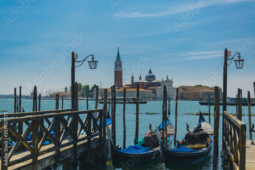 Gondolas in venice, Italy, with ancient building on an island in the distance, with sea and boats