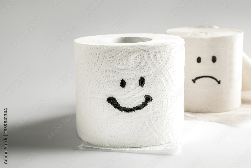 Toilet paper rolls with happy and sad smiles Toilet paper rolls with happy and sad smiles