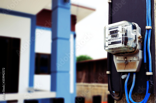 close up electric meter mounted on the front of the new house.