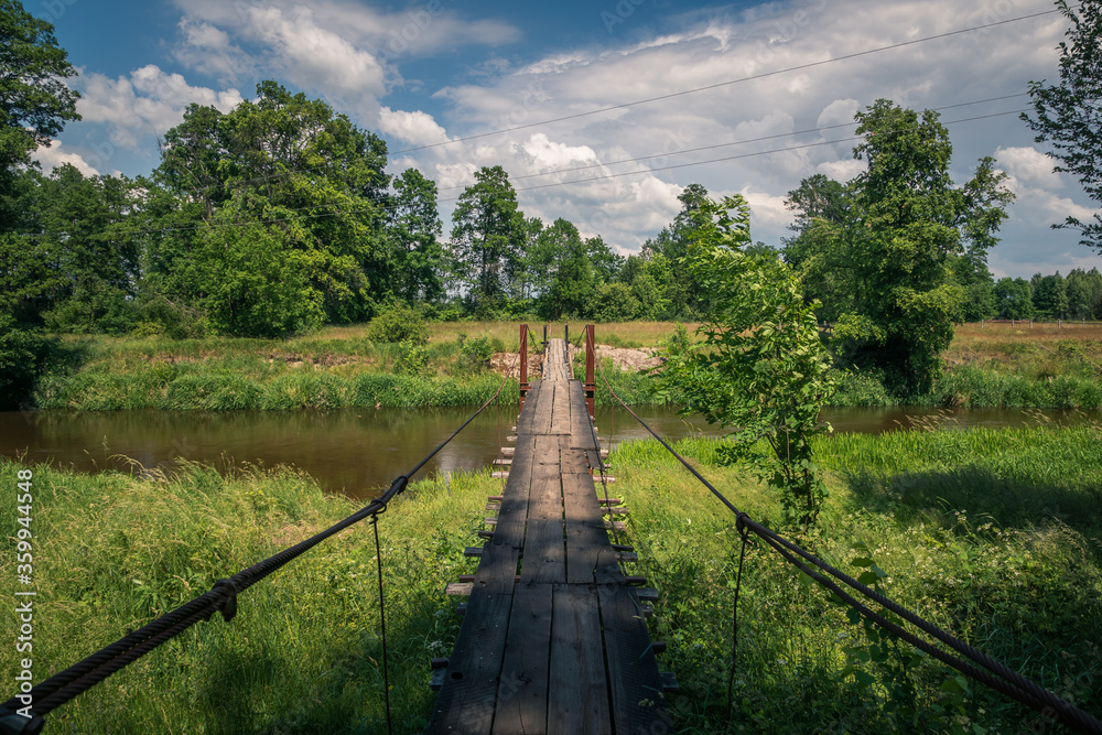 Wooden bridge over the Liwiec river at sunny day Korytnica, Masovia, Poland