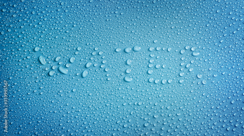 Word water of water drops on blue background