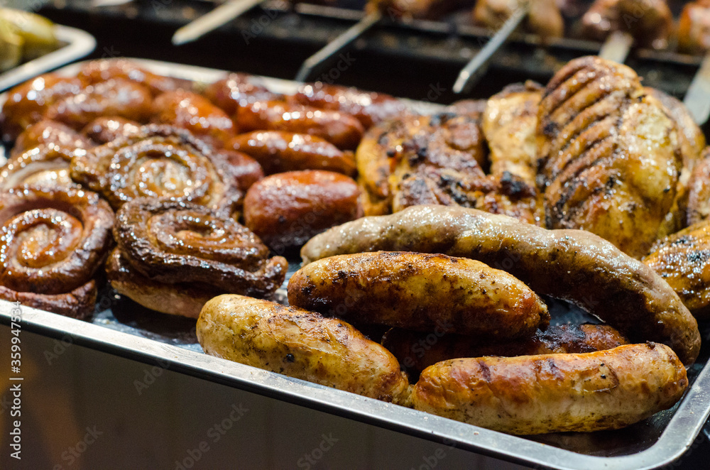 Grilling sausages on barbecue grill. Street food. Selective focus. 