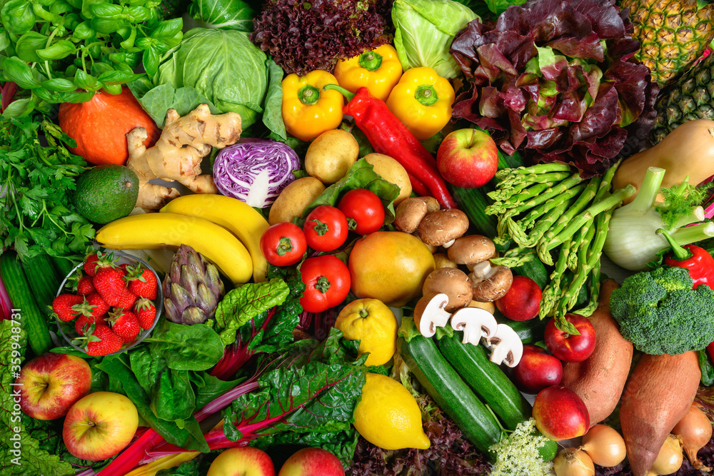 Pile of fruits and vegetables in many appetizing colors, shot from above, inviting to lead a healthy plant-based lifestyle and self-care