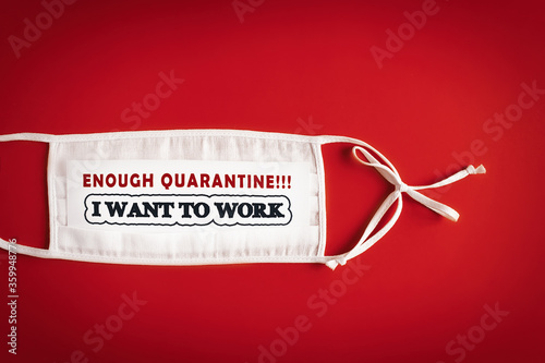 ENOUGH QUARANTINE. I WANT TO WORK. White medical mask with the inscription. People were left without money due to quarantine. Crisis and finance concept. Red background. Copy space for text