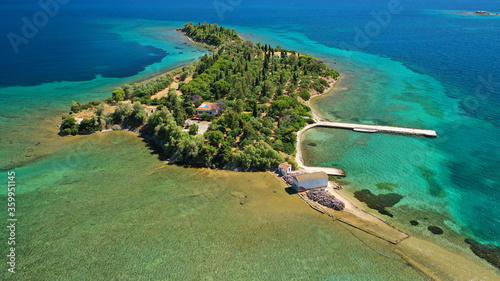 Aerial drone photo of tropical exotic island of Agia Triada in Evian bay next to famous seaside village of Eretria, central Evia island, Greece