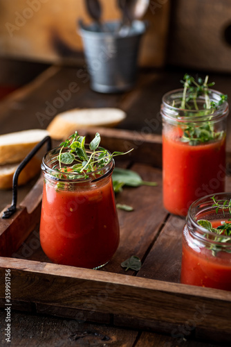 Wallpaper Mural Vegan tomato gazpacho with fresh herbs. Served in glass jars. Rustic, wooden background. Torontodigital.ca