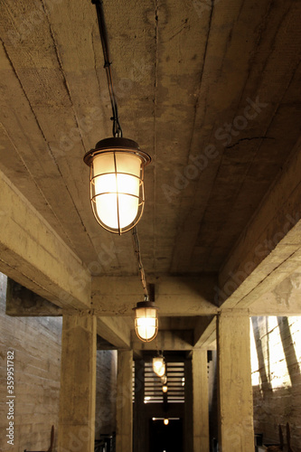 Hanging bulkhead lamp under the concrete ceiling.
