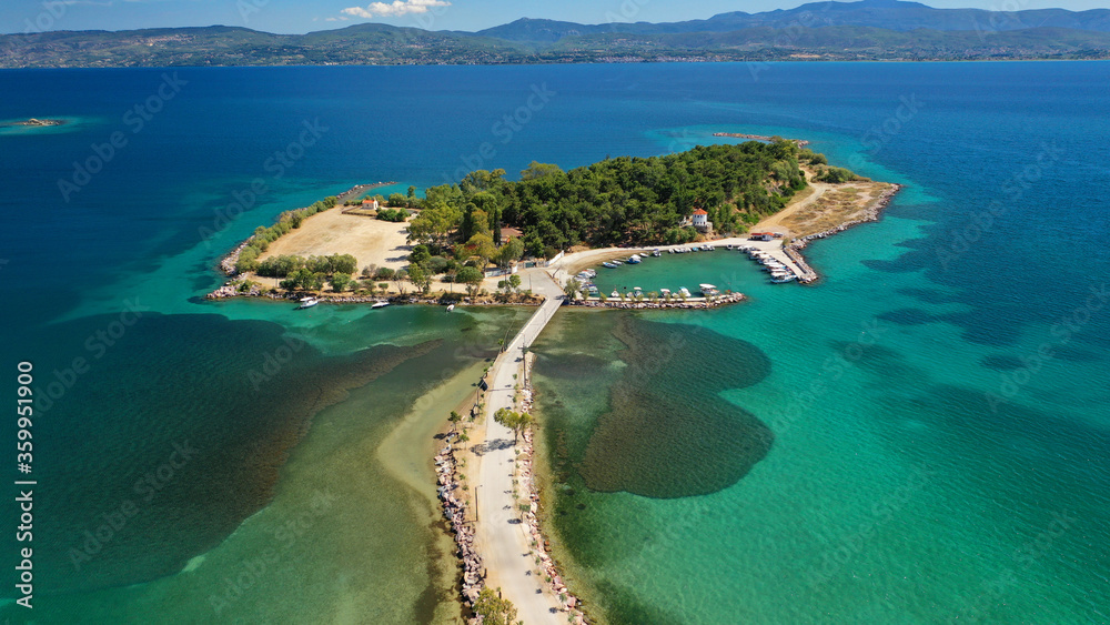 Aerial drone photo of famous island of dreams or Pesonisi connecting with small road with seaside fishing village of Eretria, Central Evia island, Greece