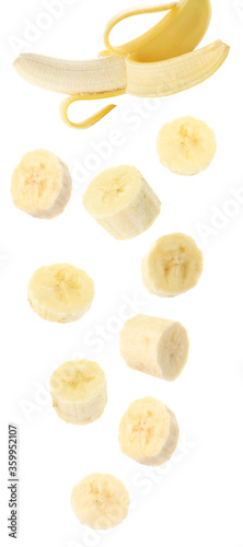Set with delicious ripe banana and pieces falling on white background