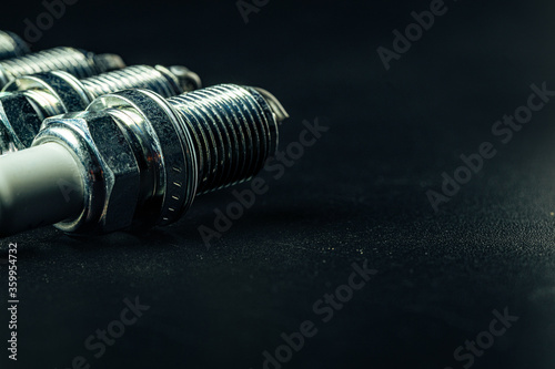 Car spark plugs on black background close up