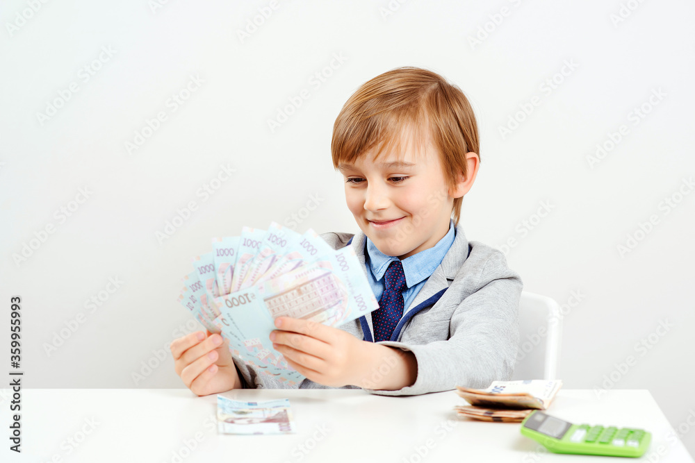 Boy saving money for future education. Money and savings concept. Boy saving money for future education. Money and savings concept.