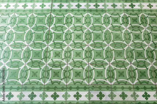 Horizontal full frame of green Mexican antique floor ceramic tiles in the interior of a church from the 1700's in the state of Oaxaca, Mexico