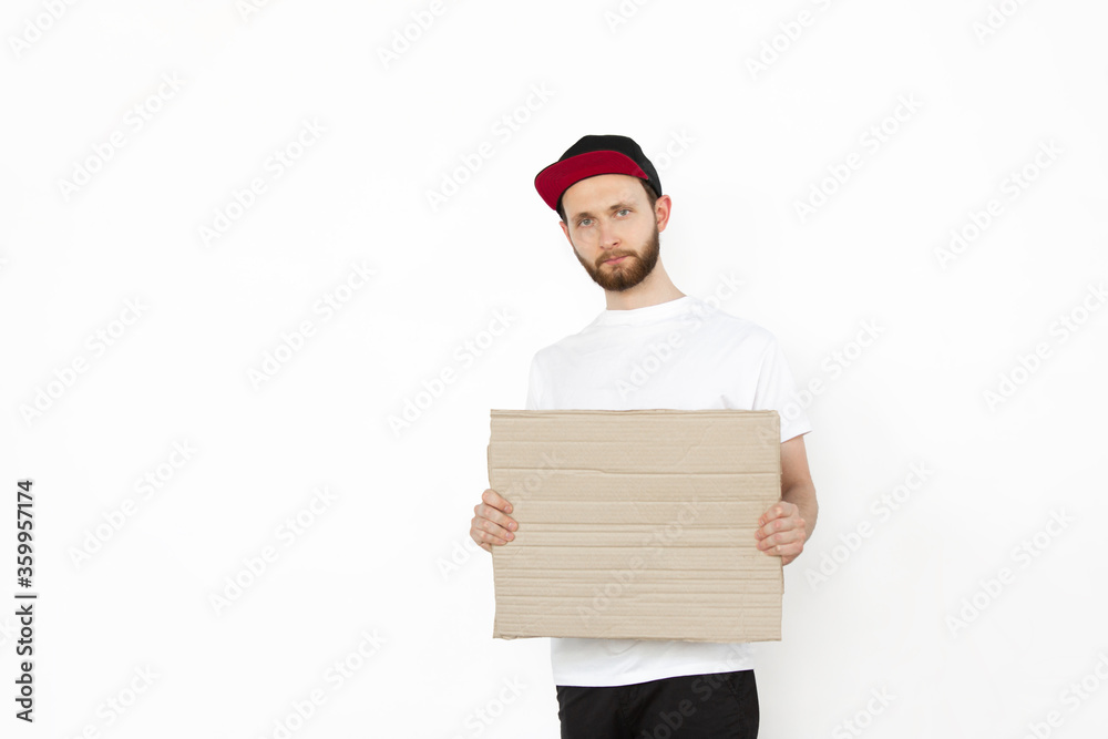 Young man protesting with blank board, sign isolated on white studio background. Activism, active social position, protest, actual problems. Meeting against human rights, abusing, freedom of choice. Young man protesting with blank board, sign isolated on white studio background. Activism, active social position, protest, actual problems. Meeting against human rights, abusing, freedom of choice.