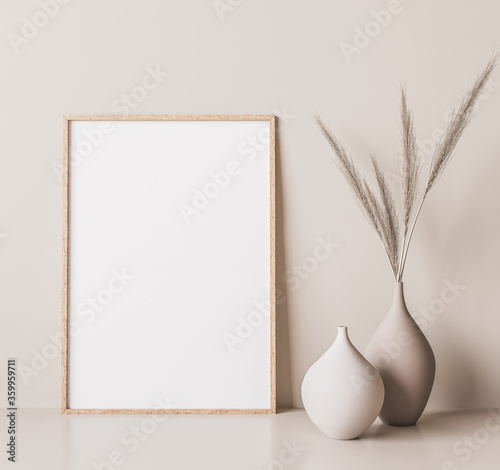 Vertical wooden frame mock up. Wooden frame poster, and simple vase with pampas on beige wall. 3D illustrations. photo