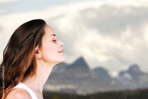 Happy young woman with perfect skin on outdoor background