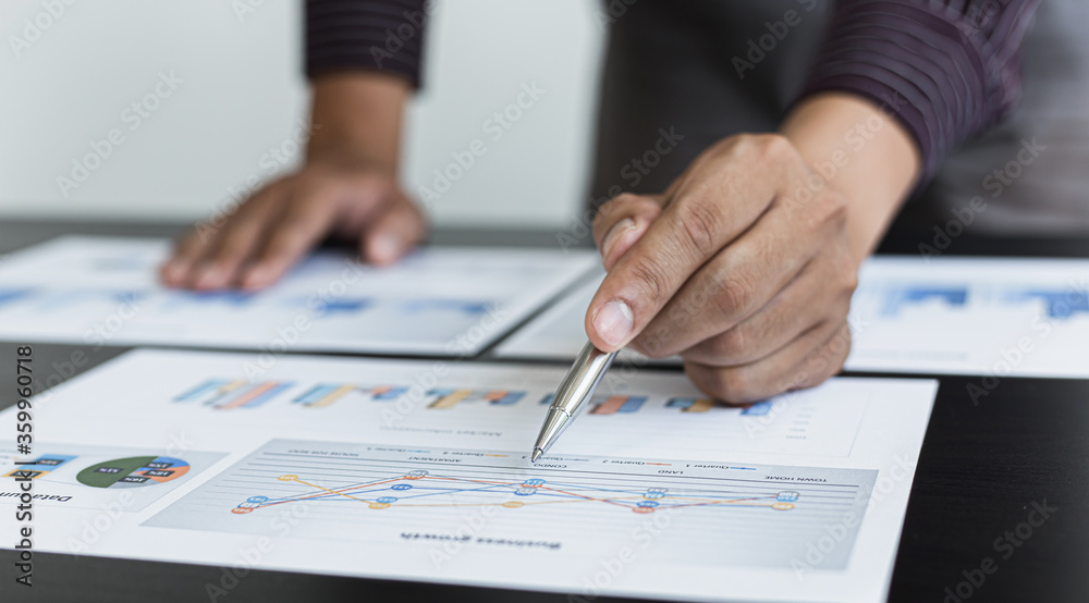 Young business men analysis graph data in the office. Young business men analysis graph data in the office.