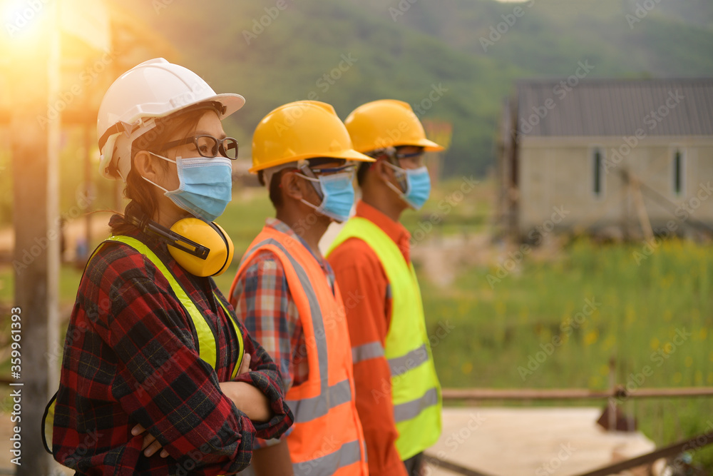 Corona or Covid-19 wear masks during the design of construction. New normal.Industrial engineering team wears a COVID 19 protective mask. Workers wear a quarantine face mask. Corona or Covid-19 wear masks during the design of construction. New normal.Industrial engineering team wears a COVID 19 protective mask. Workers wear a quarantine face mask.
