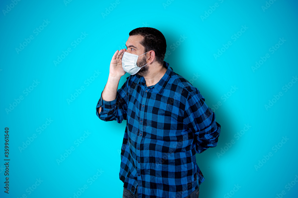 Screams, hatred, anger. Emotionally angry crying man screaming on the blue studio background. Emotional and young face. Half length male portrait. coronavirus concept. Screams, hatred, anger. Emotionally angry crying man screaming on the blue studio background. Emotional and young face. Half length male portrait. coronavirus concept.