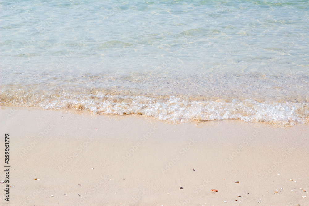 Sandy beach and blue sea in summer soft focus