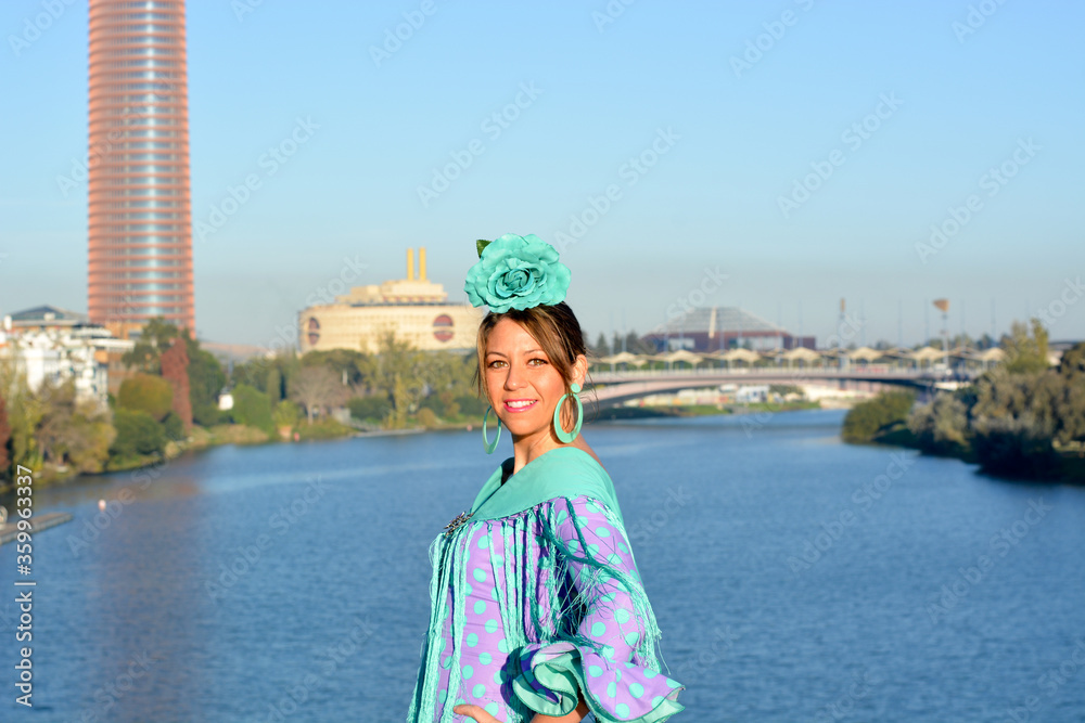 girl with flamenco dress on the triana bridge in Seville