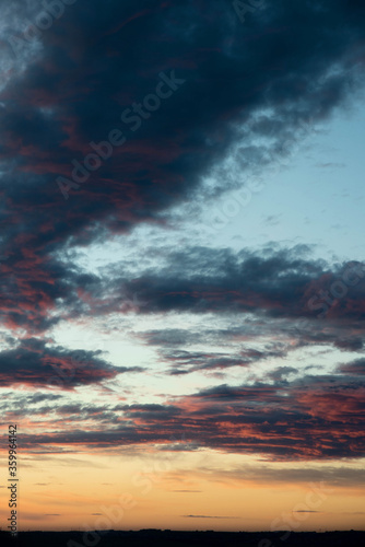 the sky at sunset is orange and red with clouds, the sky is dramatic colors