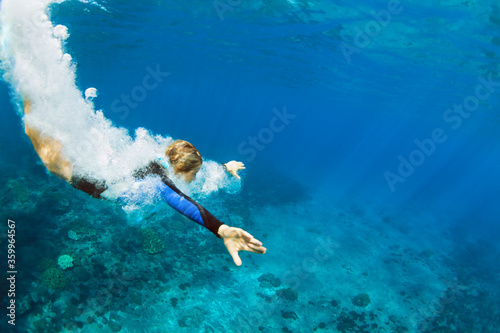 Fényképezés Happy family - active teenage girl jump and dive underwater in tropical coral reef pool