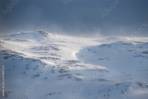 Distant snow covered mountains in the wind