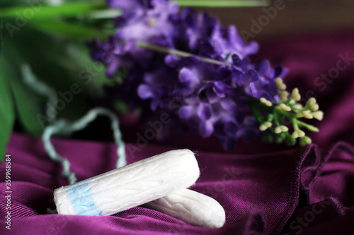 Women's tampons and purple flowers