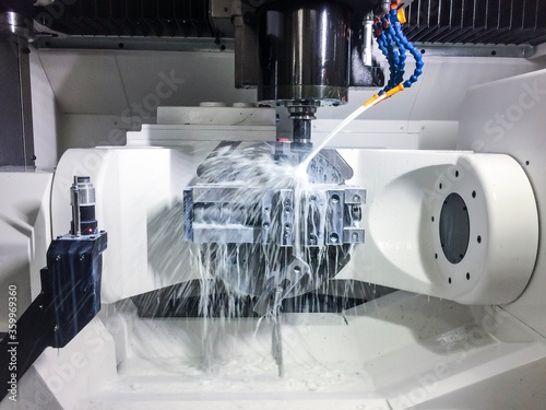 New high performance 5 axis CNC machining centre. Milling process with emulsion. photo