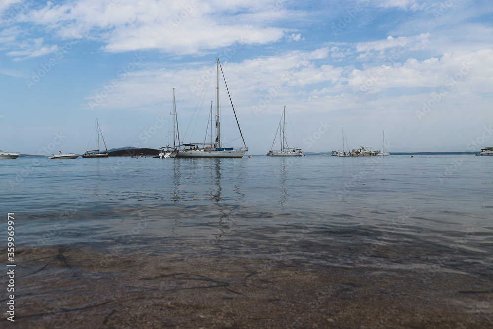 Beautiful, anchored yachts at Vrgada island sand beach, created by landslide, popular tourist attraction in central Dalmatia, Croatia Beautiful, anchored yachts at Vrgada island sand beach, created by landslide, popular tourist attraction in central Dalmatia, Croatia
