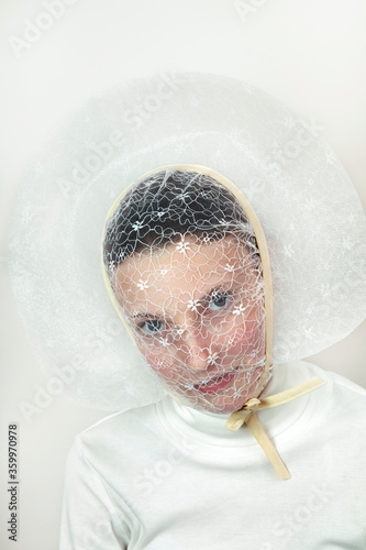 Portrait of teenage girl wearing bonnet white veil
