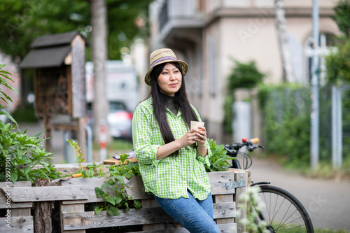 Woman harvesting in urban garden photo