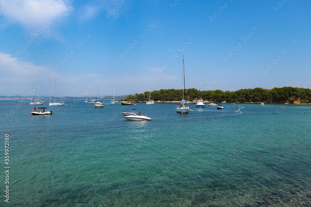 Beautiful Vrgada island bay filled with yachts and boats during tourist season