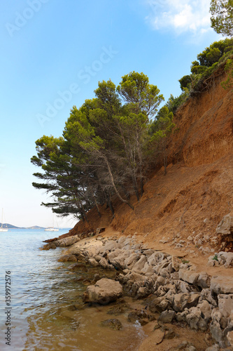 Consequences of landslide on Vrgada island, collapsed land falling into water, creating beaches of red sand