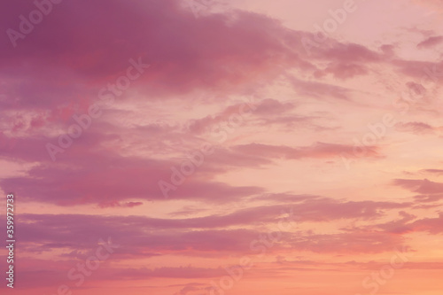 Beautiful bright colorful pink red yellow clouds on dark sky at sunset or sunrise. Evening or morning sky natural eco background. Amazing nature texture surface wallpaper.