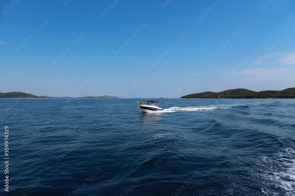 Vrgada/Croatia-July 24th,2017: Speed boat passing by our boat when returning to the coast of central Dalmatia from Vrgada island in open, adriatic waters