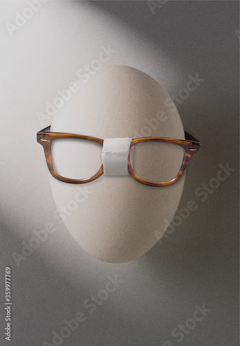 eyeglasses repaired with tape on an egg photo