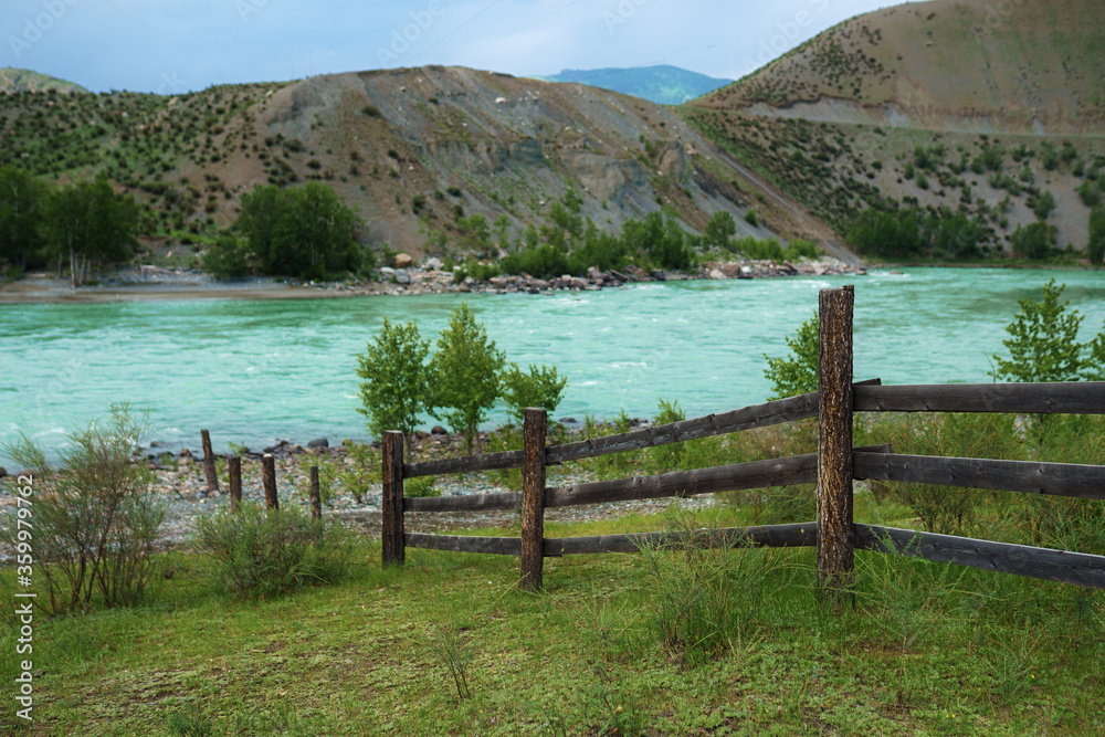 wooden fence by the Katun river in Altai