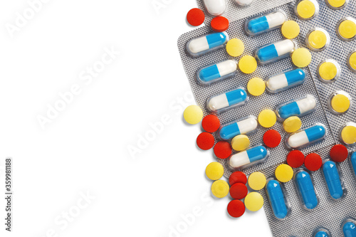 pile of medical pills in red, blue colors in silver plastic packaging