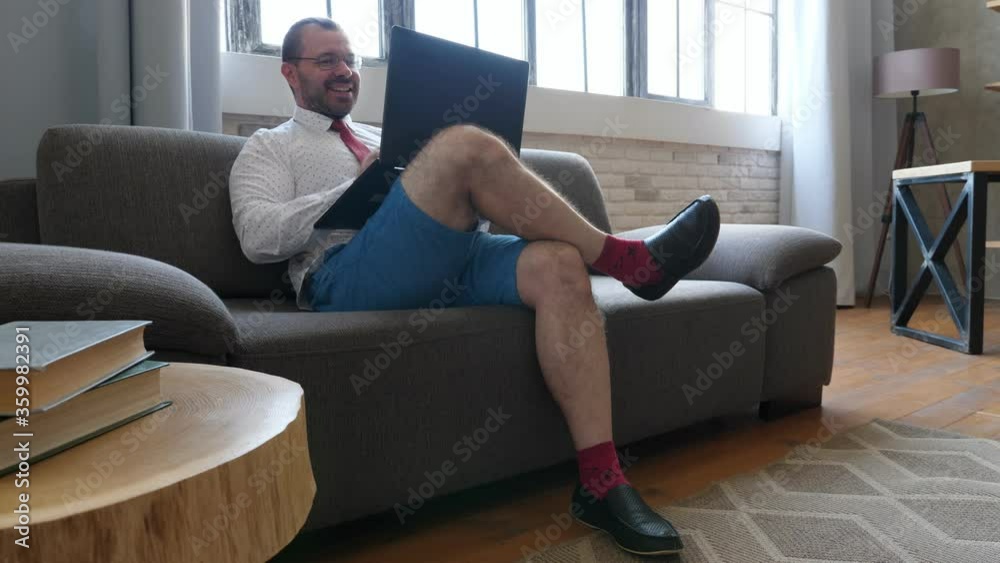 Remote work. A businessman in shorts and a tie discusses in a video chat. Remote work. A businessman in shorts and a tie discusses in a video chat.