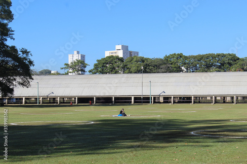 Sao Jose dos Campos, Sao Paulo, Brazil - Jun, 20, 2020: Woman sunbathes in one of the Social Distancing Circles in Roberto Burle Marx Municipal Park. photo