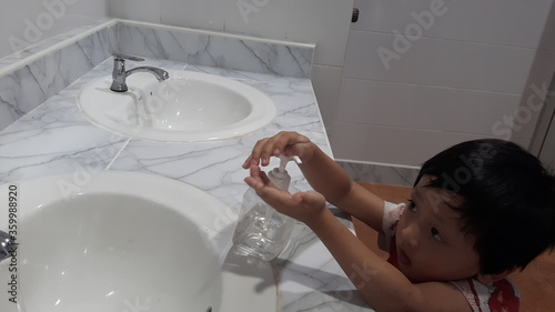 A child washing hands in the sink For sanitation and to reduce the spread of COVID-19, the concept of hygiene, prevention of coronavirus infection.