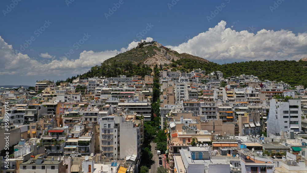 Aerial drone panoramic photo of Lycabettus hill and Athens urban cityscape with beautiful sky and clouds, Attica, Greece